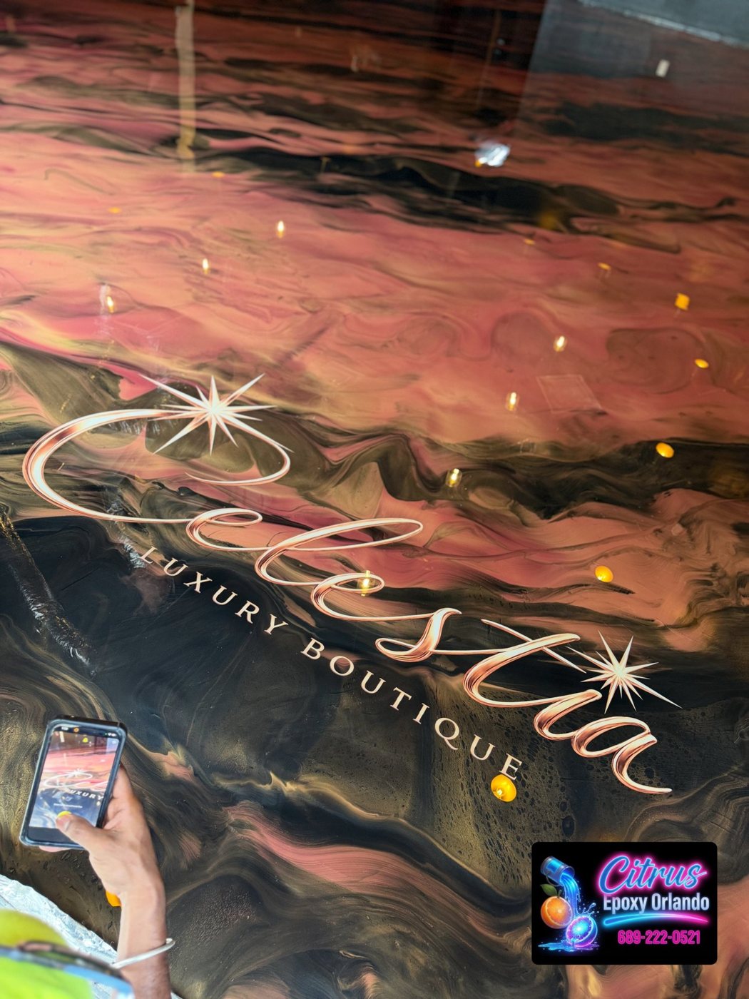 Metallic epoxy floor with custom Celestia boutique logo